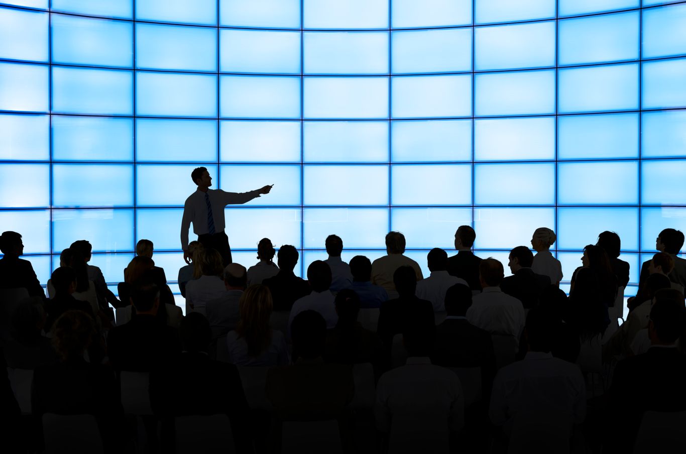 Man presenting to an audience in a meeting